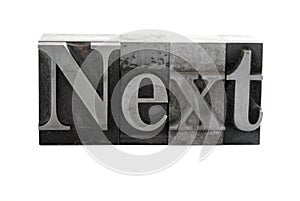 The word 'Next' in metal type