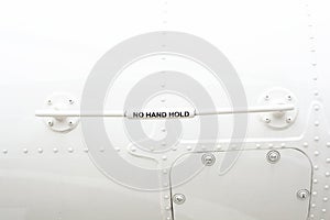 The word `No hand hold` wrote on the hand holder beware people is a part of the helicopter