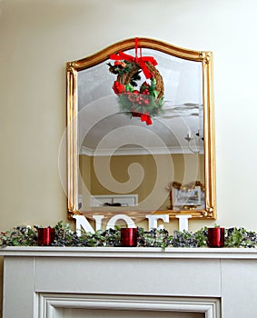 The word & x22;NOEL& x22; spelt in large letters on a lovely mantlepiece,