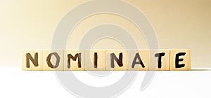 Word NOMINATE made with wood building blocks photo