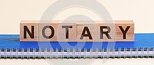 Word NOTARY formed by alphabet blocks, white background, front view photo