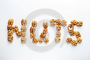 Word NUTS made of walnut on white background