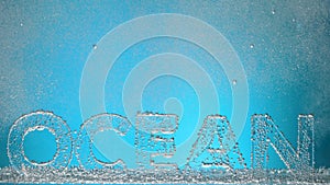Word ocean underwater in oxygen bubbles on blue background.