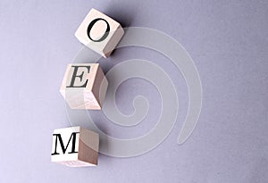 Word OEM on wooden block on the grey background