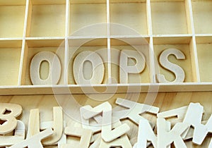 Word oops made with wooden letters alphabet