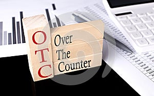 Word OTC Over The Counter made with wood building blocks, business concept