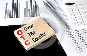 Word OTC Over The Counter made with wood building blocks, business concept