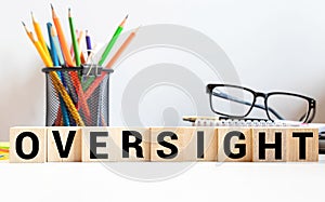 word Oversight on wooden block, concept business photo