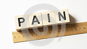 Word PAIN made with wood building blocks