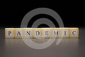 The word PANDEMIC written on wooden cubes isolated on a black background