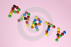 Word party of colored candies on a pink background