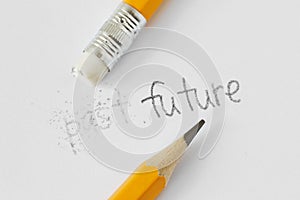 The word past erased with a rubber and the word future written with a pencil on white paper - Concept of time, clearing the past