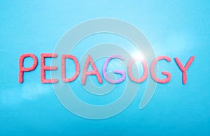 The word pedagogy in red letters on a blue background. Learning and Education Science Concept