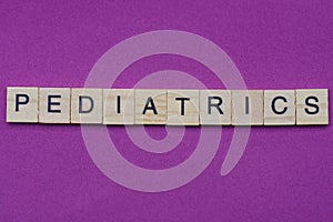 Word pediatrics from small gray wooden letters