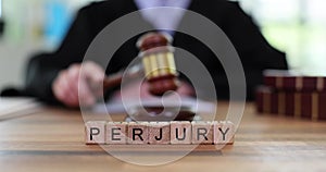 Word Perjury against judge knocking gavel on court table