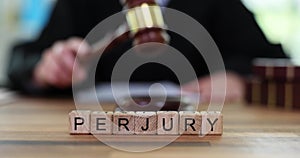 Word of perjury and judge and banging gavel on court table