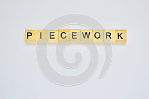 Word piecework. Top view of wooden blocks with letters on white surface