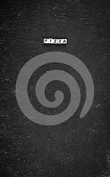 Word pizza on black stone background