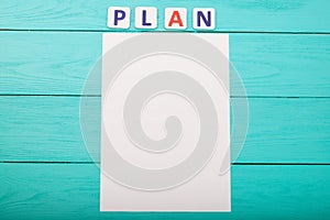 Word plan on blue wooden background. Top view. Copy space. Mock up. Template blank paper. Business plan