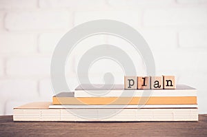 The word PLAN, letters and copy space background, vintage