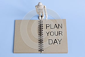 Word PLAN YOUR DAY on a blue background