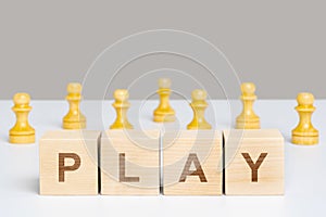 The word play on wooden cubes among chess pieces of pawns. The concept of gaming tournaments
