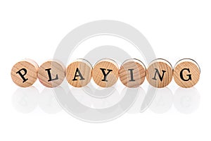 Word Playing from circular wooden tiles with letters children toy.