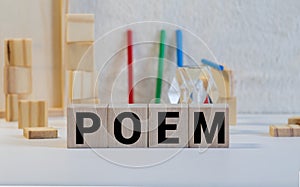 Word poem made with block wooden letters next to a pile of other letters over the wooden board surface composition