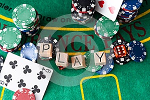 The word poker on wooden cubes, poker chips with playing cards on the green casino table. gamble