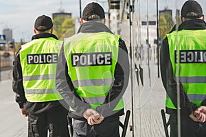 Word police written on reflective vests of police officers