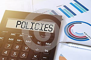 Word POLICIES on calculator. Business and finance concept