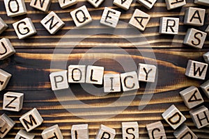 word policy composed of wooden cubes with letters