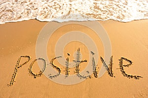 Word positive draw on beach