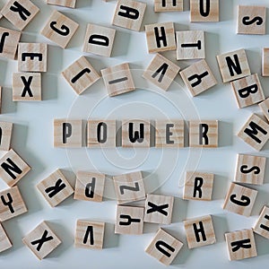 The word power spelled out in wooden craft letters surrounded by letters