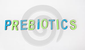 The word PREBIOTICS is written in colored wooden letters