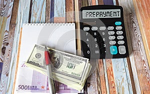 The word PREPAYMENT on a calculator, next to euros and dollars.
