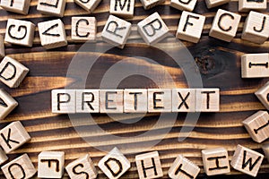 word pretext composed of wooden cubes with letters