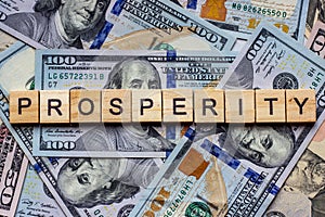 The word prosperity on dollar usa background. Welfare, sufficiency and wealth concept.