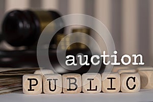 Word PUBLIC AUCTION composed of wooden dices