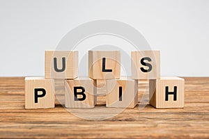 word publish on wooden cubes and