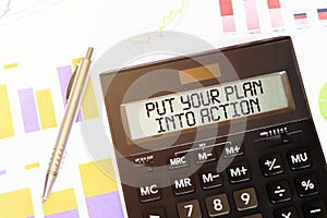 Word PUT YOUR PLAN INTO ACTION on calculator. Business and tax concept