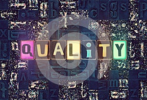 The word Quality as neon glowing unique typeset symbols, luminous letters quality