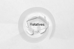 Word Relatives on white isolated background through the wound hole in the paper