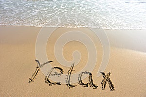 Word relax drawn on the beach