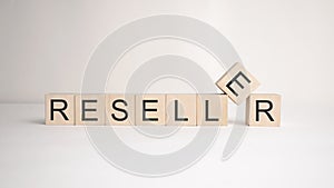 The word reseller is written on wooden cubes on a light background. Business concept