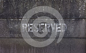 Word reserved spray painted on concrete blocks fence