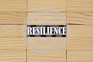 The word resilience among the wooden bars. Business concept