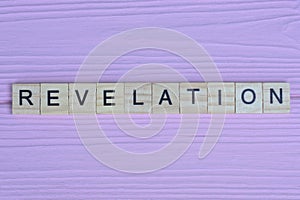 word revelation from small gray wooden letters
