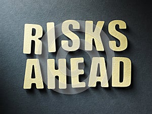 The word Risks Ahead on paper background