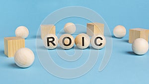 word ROIC, inscription on wooden balls. information concept